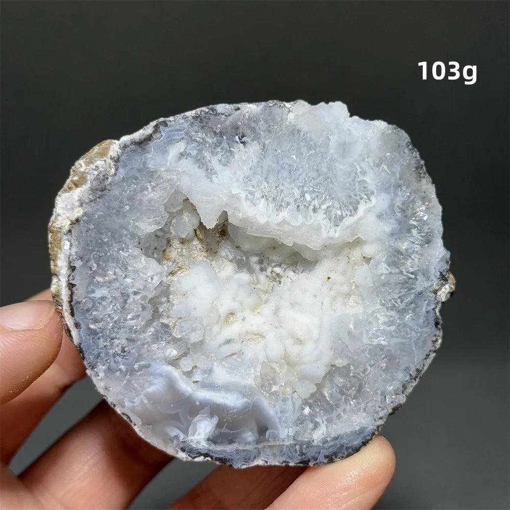 Natural Agate crystal cave egg, 103g, with a sparkling white druzy interior and banded gray exterior.