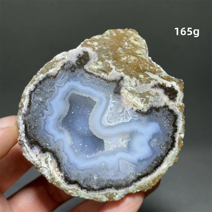 Natural Agate geode slice with a sparkling blue druzy crystal cave, banded exterior, 165g.