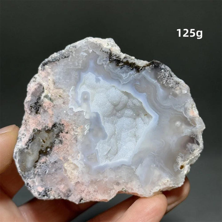 Natural Agate geode slice with a sparkling white druzy crystal cave, banded rust, cream, and gray exterior.