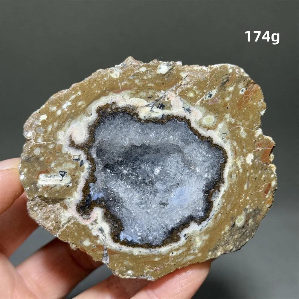 Natural Agate crystal cave egg with a banded brown exterior and sparkling white druzy interior, 174g.