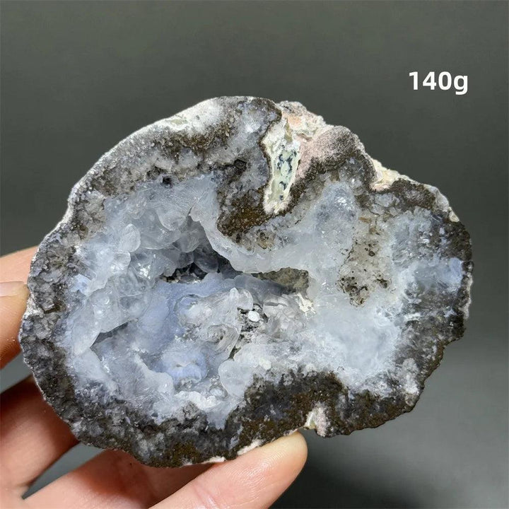 Natural Agate geode slice with a sparkling, light blue druzy crystal interior, weighing 140g.