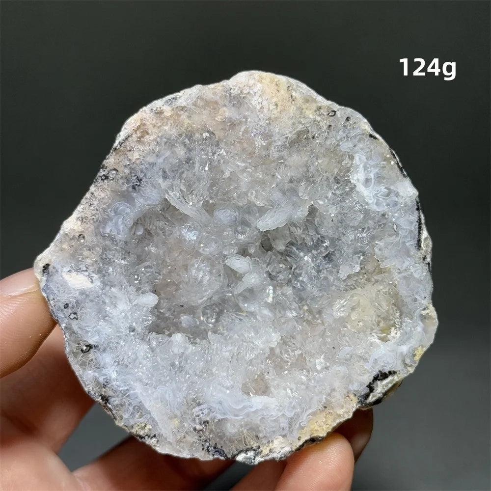 Natural Agate crystal cave egg with sparkling white druzy interior, 124g. Supports grounding and healing.