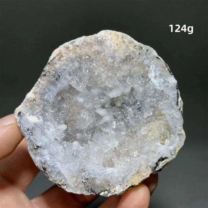 Natural Agate crystal cave egg with sparkling white druzy interior, 124g. Supports grounding and healing.