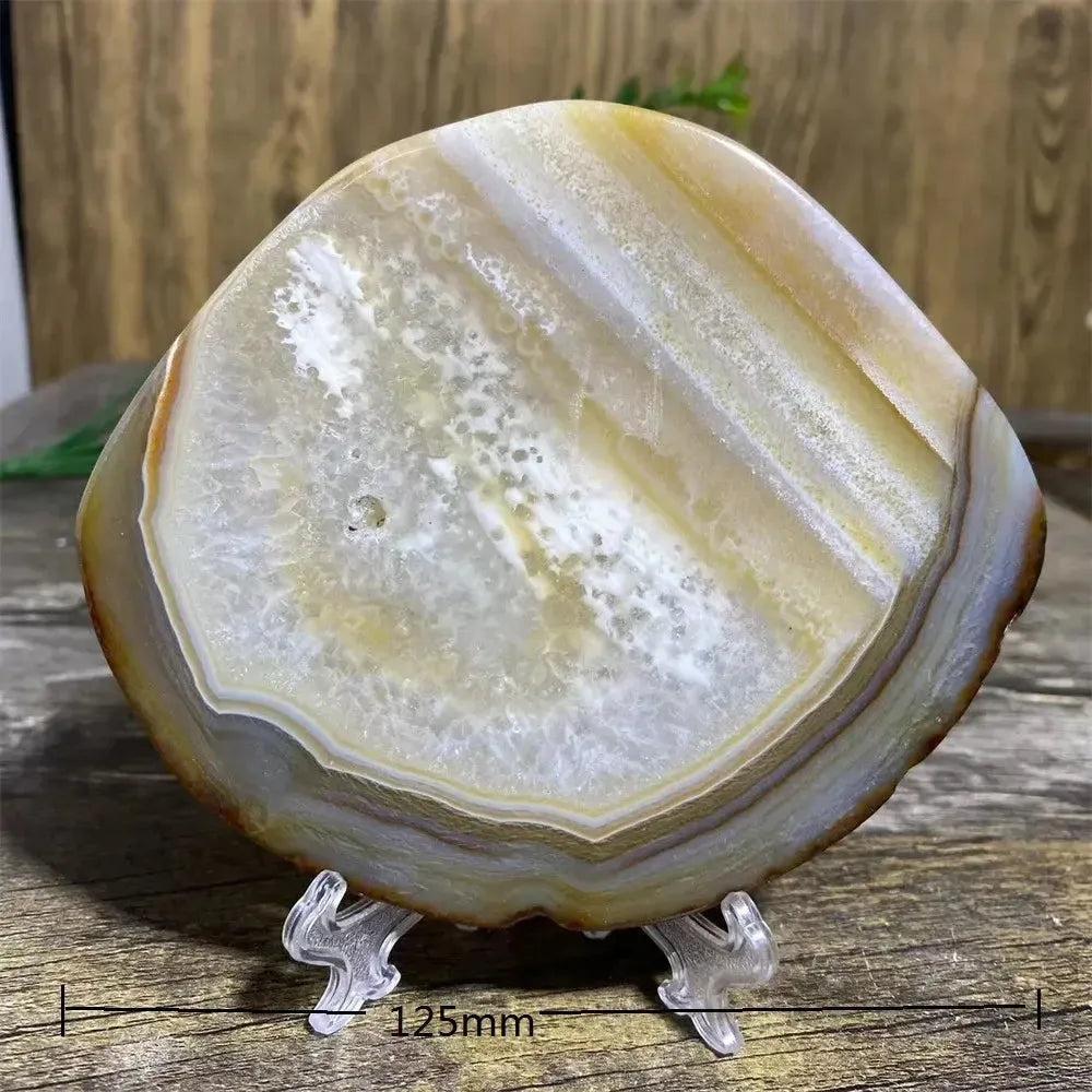 Stunning Agate Slice with Stand, showcasing warm amber, cream, and translucent bands for grounding and balance.