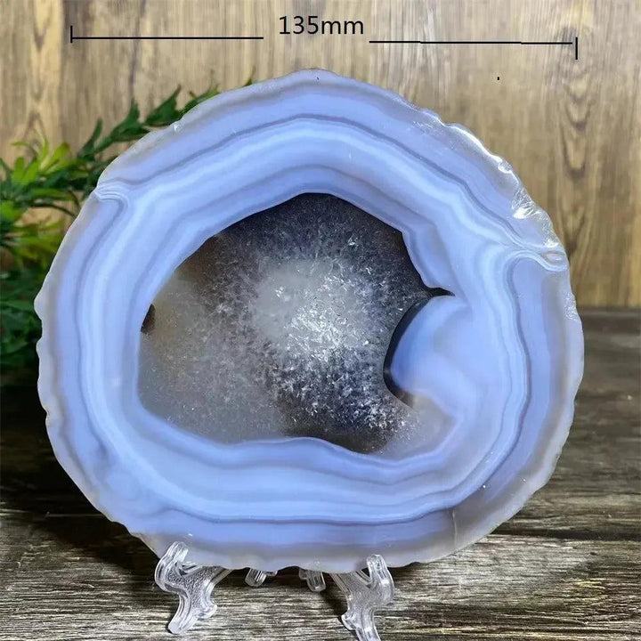 Stunning Agate Slice with Stand, showcasing calming blue and white bands, perfect for grounding and emotional balance.