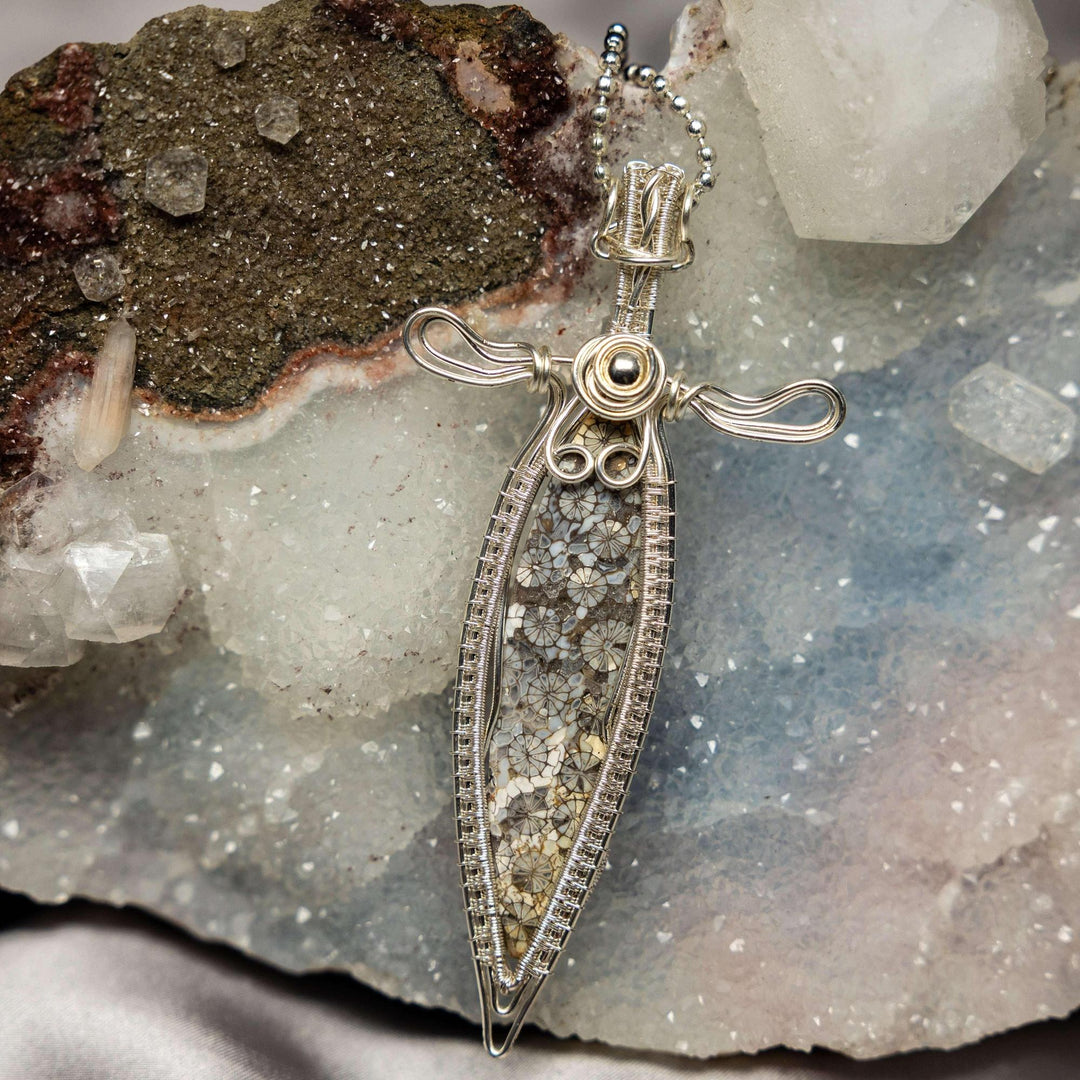 Agatized Coral Wire Wrap Pendant: Intricate silver wire frames a fossilized coral stone with unique floral patterning.