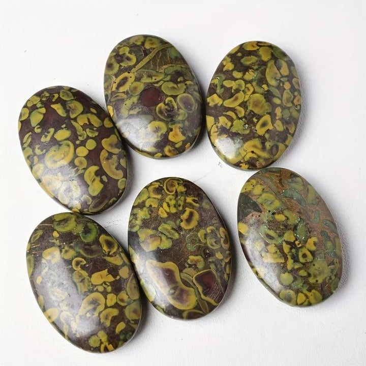 Polished Ajooba Jasper Crystal Palm Stones with grounding yellow, green, and brown earthy swirls.