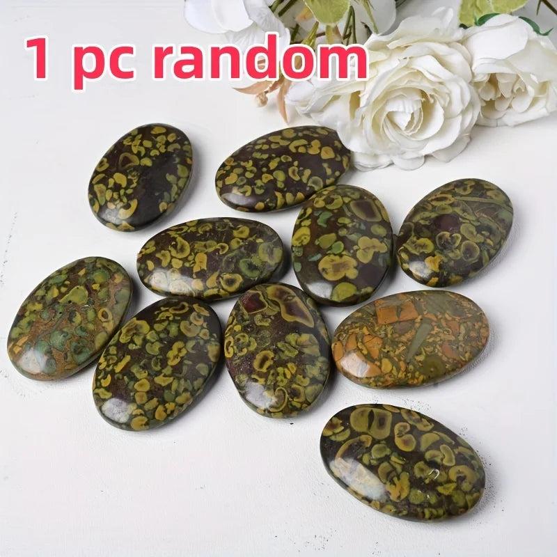 Polished Ajooba Jasper Crystal Palm Stones with earthy green, yellow, and brown swirls for grounding.