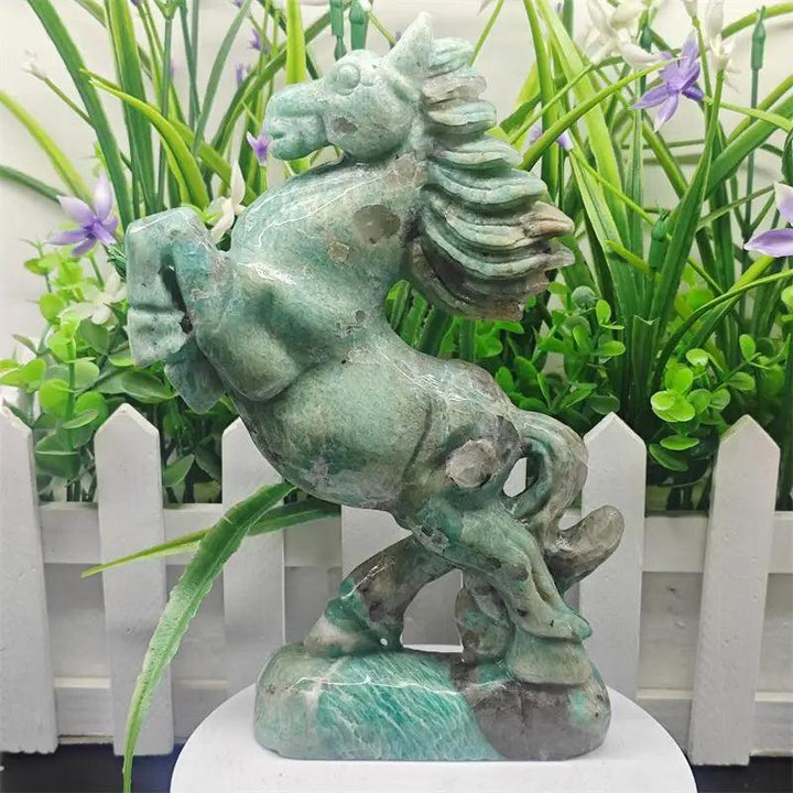 Vivid teal-green Amazonite crystal carved horse sculpture with white veining, symbolizing power and heart chakra energy.