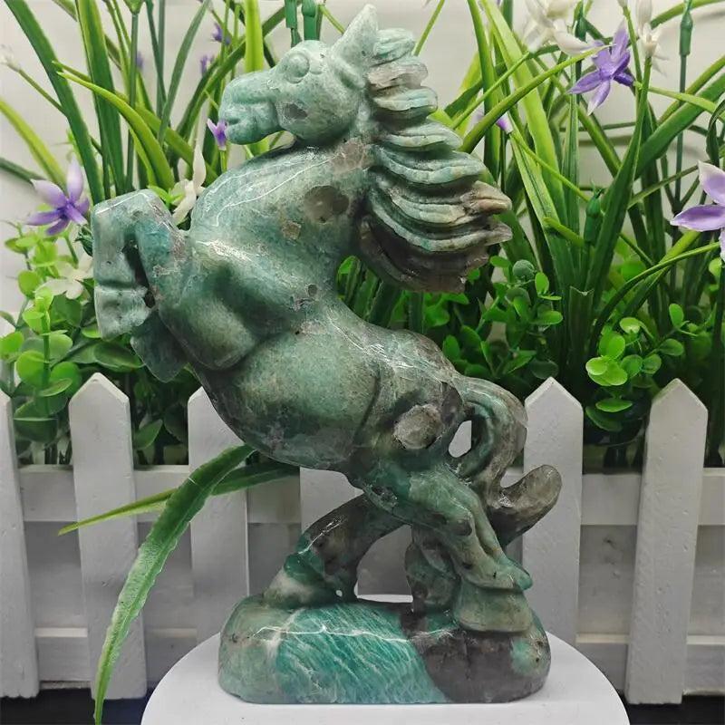 Amazonite crystal carved horse sculpture in vivid teal-green with white veining, symbolizing power and heart chakra energy.