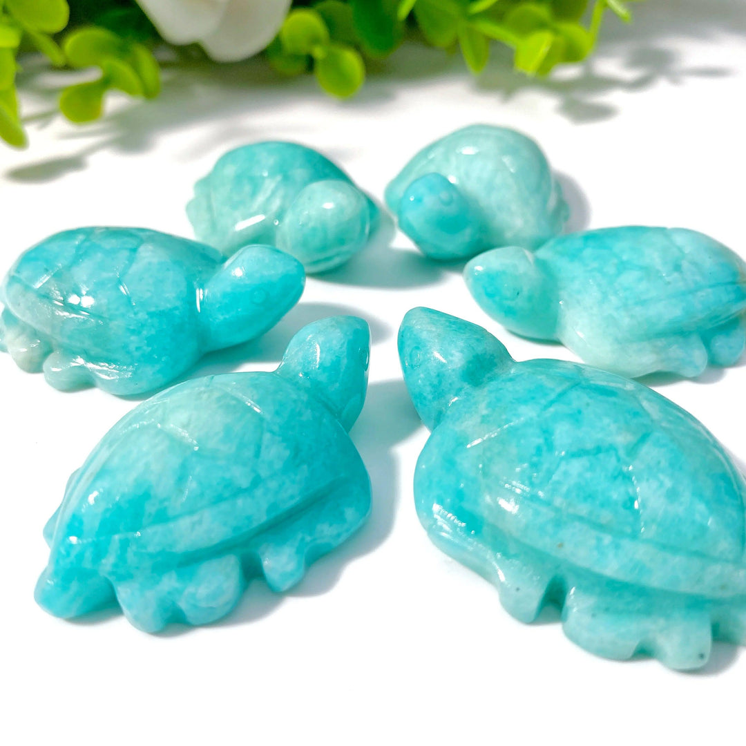 Hand-carved amazonite sea turtle figurines in natural teal and cream tones, symbolizing peace and clear communication.