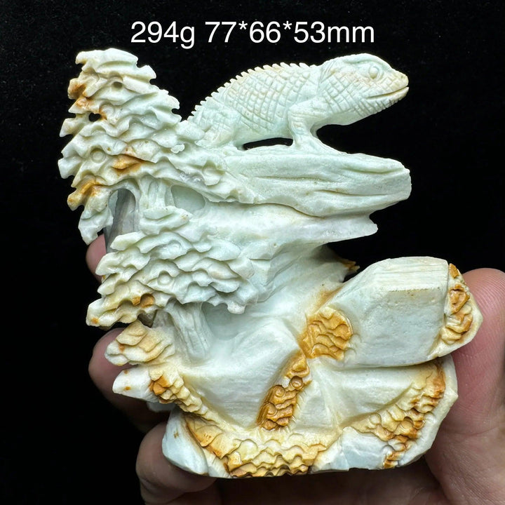 Hand-carved amazonite lizard figurine on a natural stone base with trees, showcasing teal, seafoam, and cream swirls.