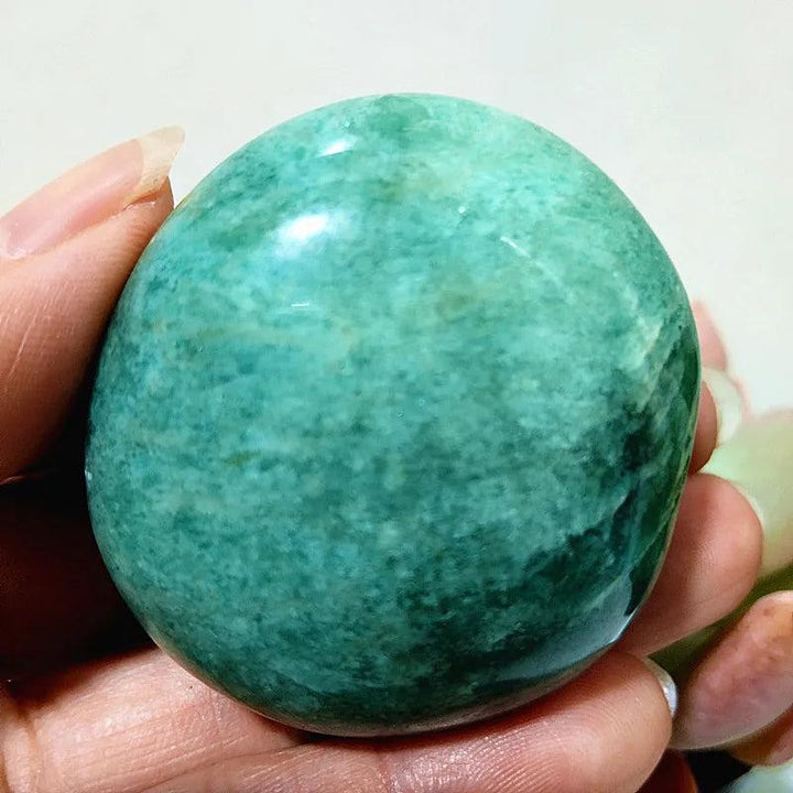 Amazonite Crystal Polished Palm Stone: Smooth, calming teal and cream stone for peace and clear communication.