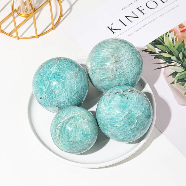 Polished Amazonite crystal spheres in calming blue-green hues for emotional balance and peaceful energy.