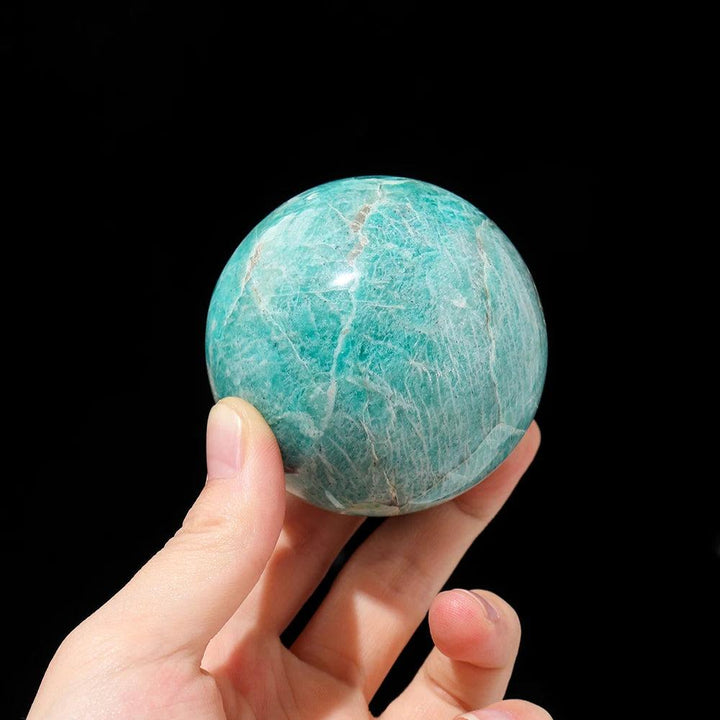 Polished Amazonite crystal sphere with soothing blue-green hues, perfect for emotional balance and calm energy.