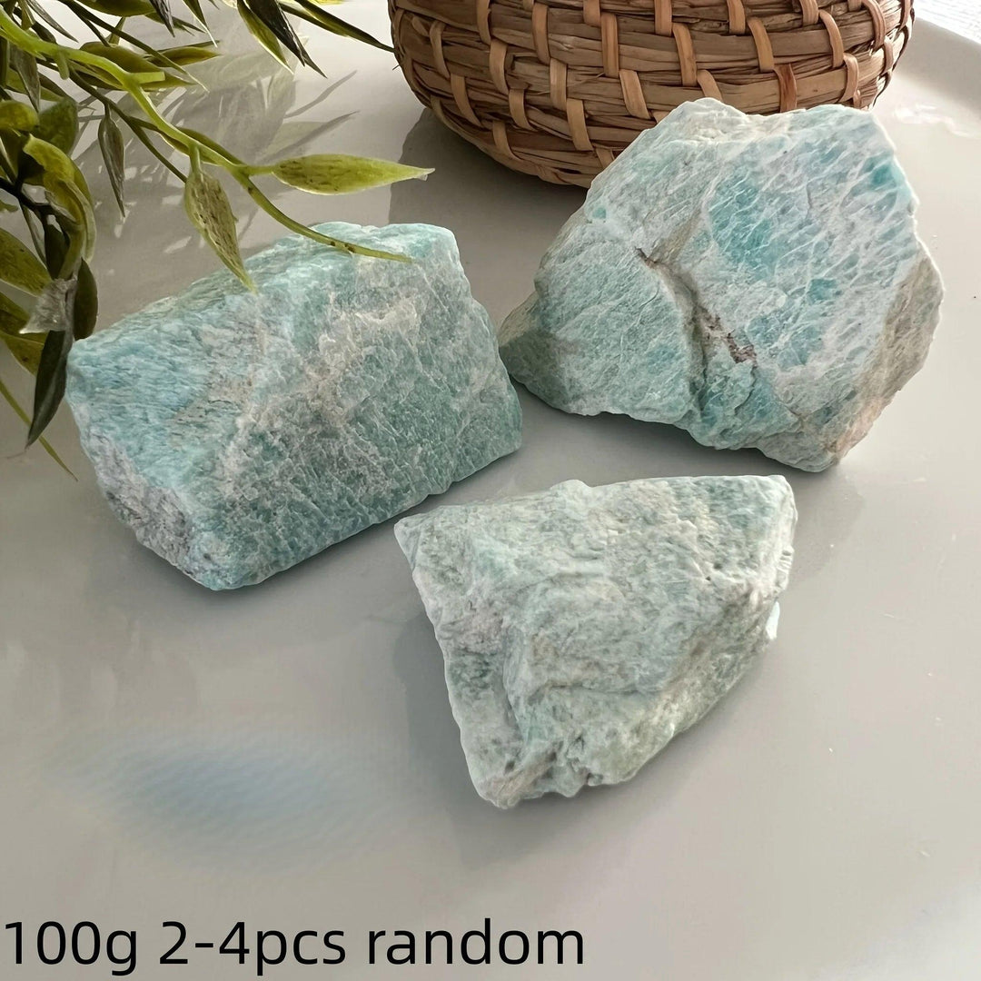 Three raw Amazonite crystals with natural blue-green textures for calming healing and heart chakra energy.