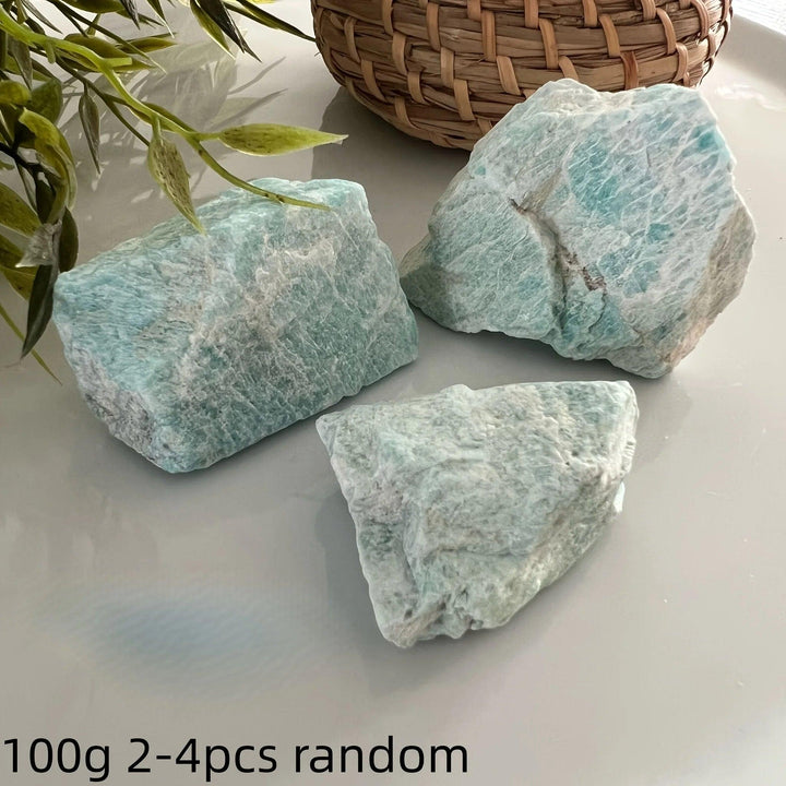 Three raw Amazonite crystals with natural blue-green textures for calming healing and heart chakra energy.