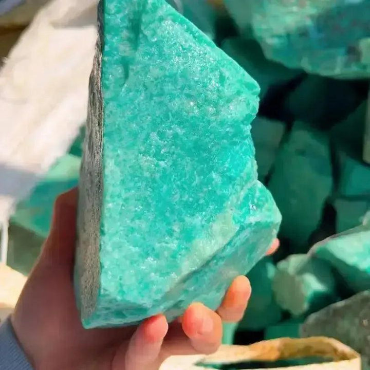 Raw Amazonite crystal from Crystal Destiny, a large, unpolished turquoise-green stone with natural textures.