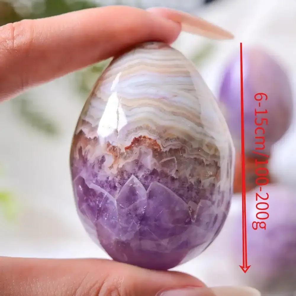 Hand-polished AAAA+ Amethyst Agate egg with purple crystal clusters and white, gray, and brown banding for meditation.