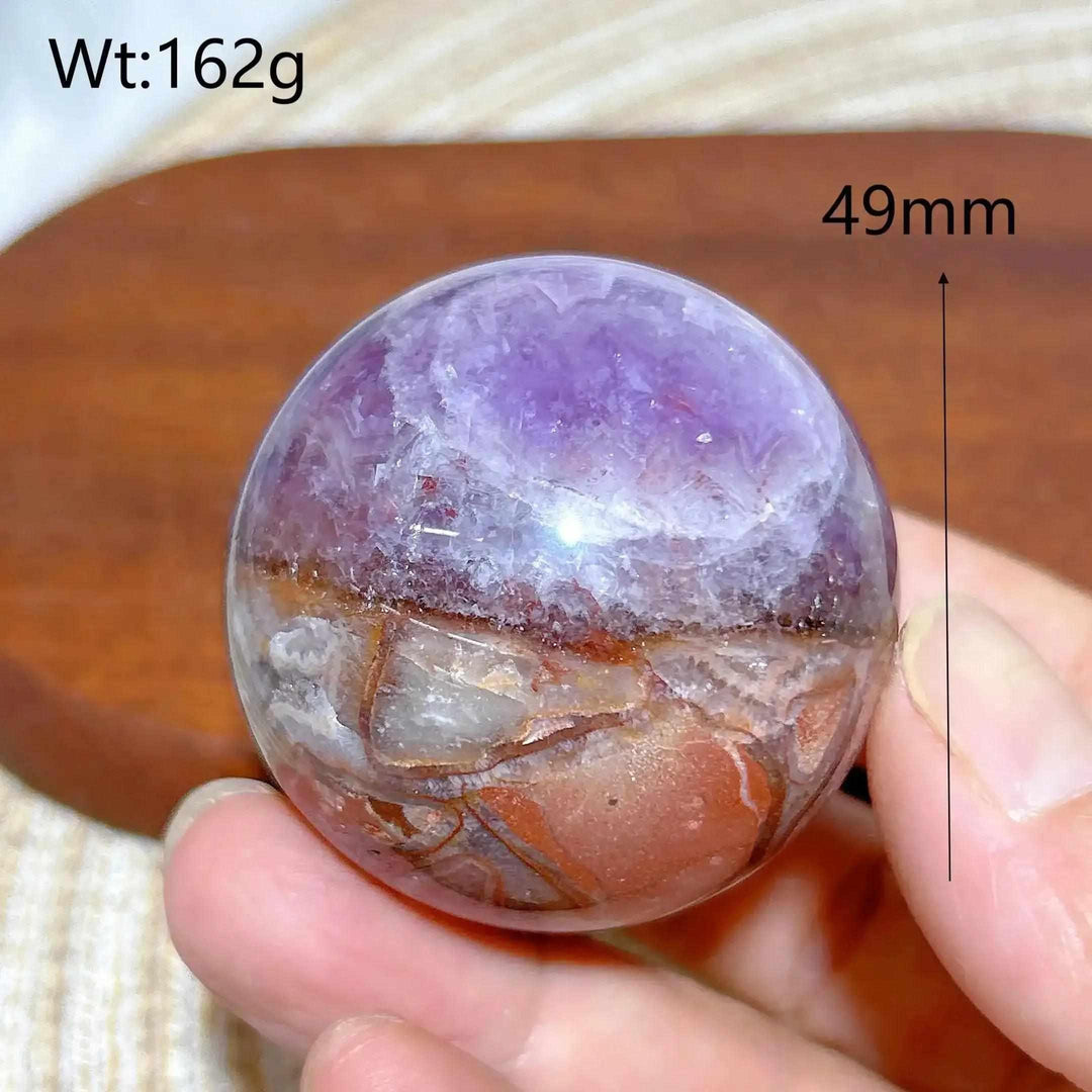 Hand-polished Amethyst Agate sphere featuring purple, gray, and brown bands for peaceful focus and Crown chakra healing.