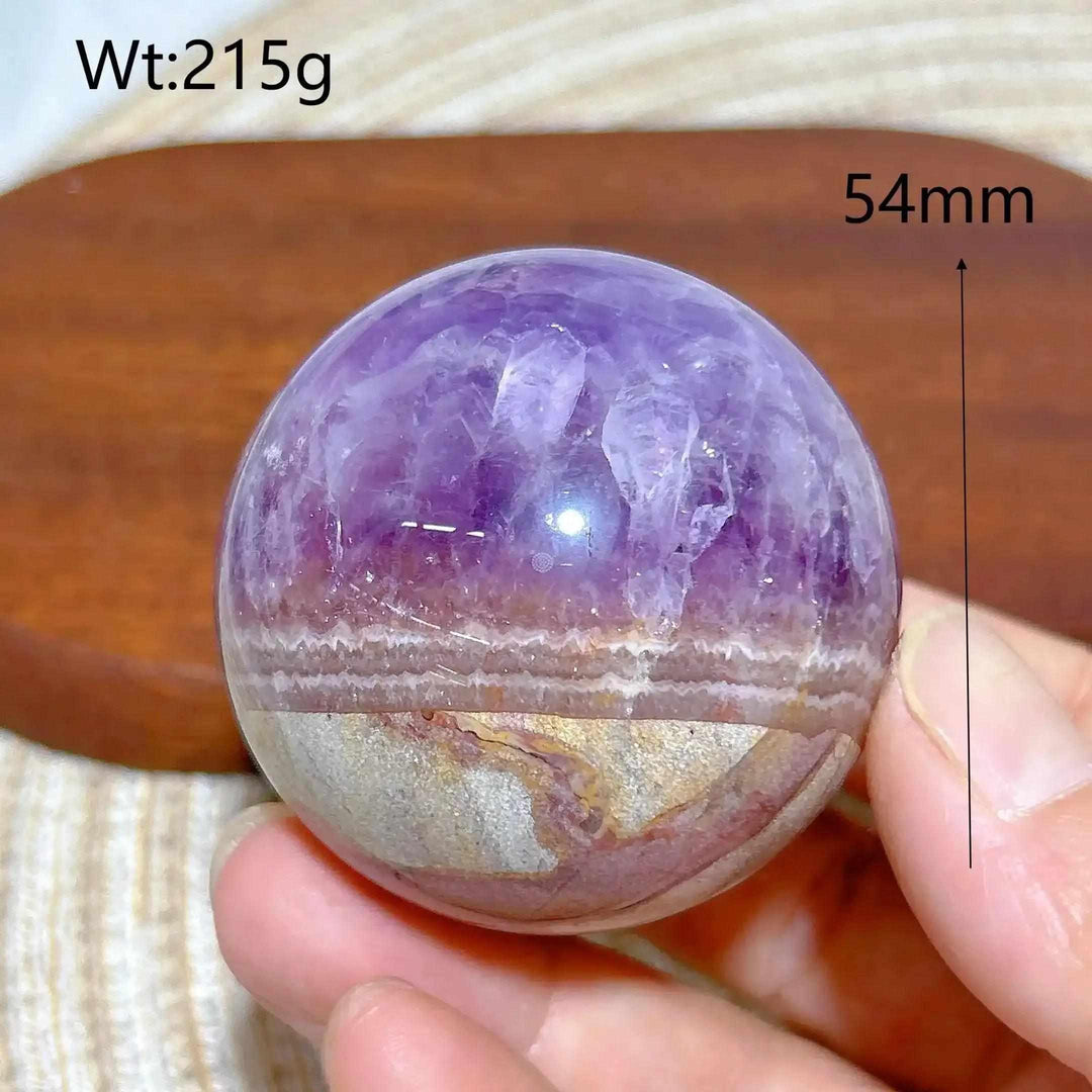 Polished 54mm Amethyst Agate sphere featuring purple amethyst and banded white, gray, and brown patterns for peaceful focus.