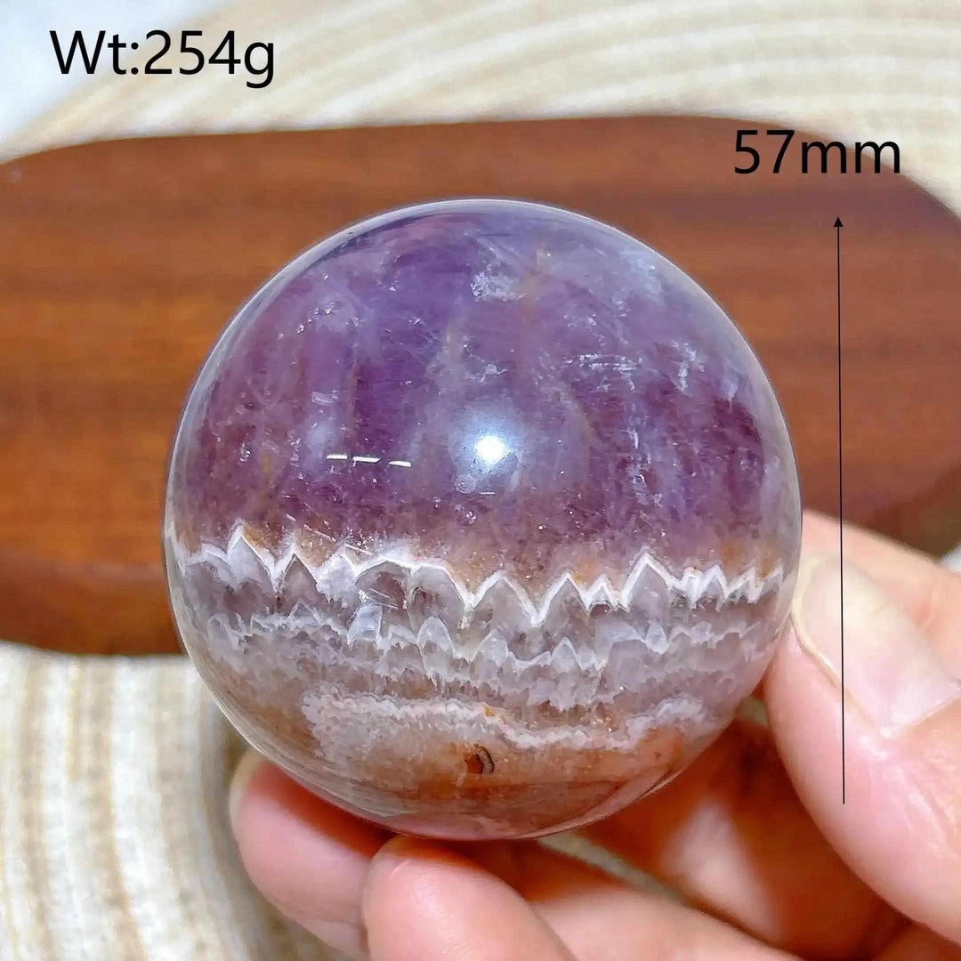 Hand-polished Amethyst Agate sphere featuring purple hues and white banded patterns for peaceful meditation and focus.