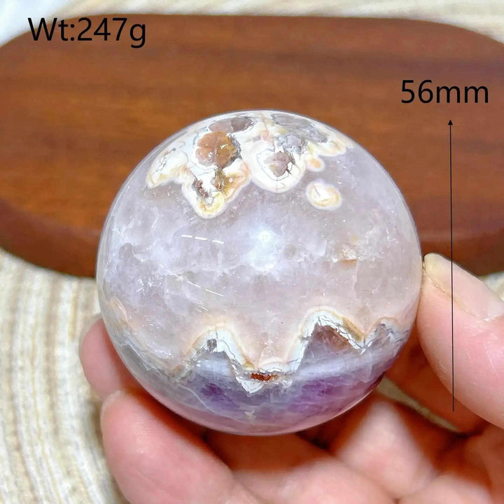 Hand-polished 56mm Amethyst Agate sphere featuring purple amethyst and banded white, gray, and brown patterns for focus.