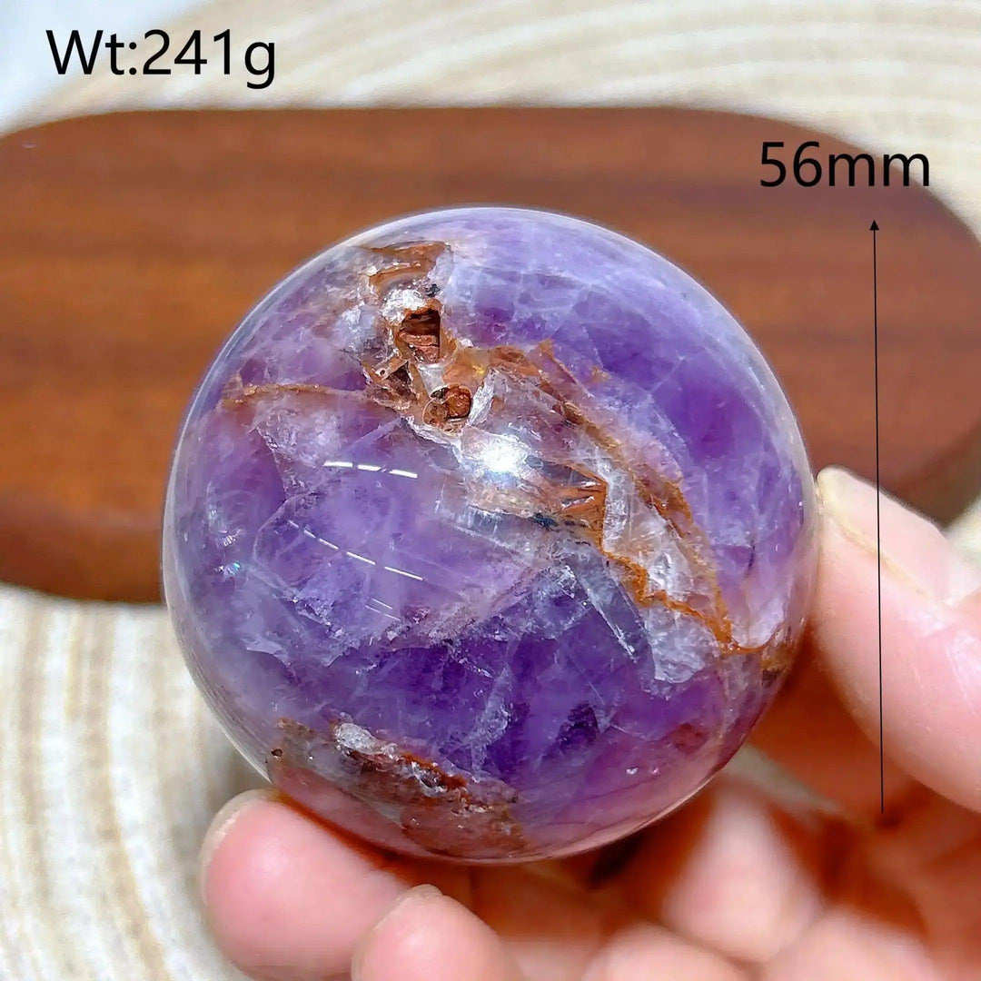 Hand-polished 56mm Amethyst Agate sphere featuring purple hues and banded patterns for peaceful meditation and focus.