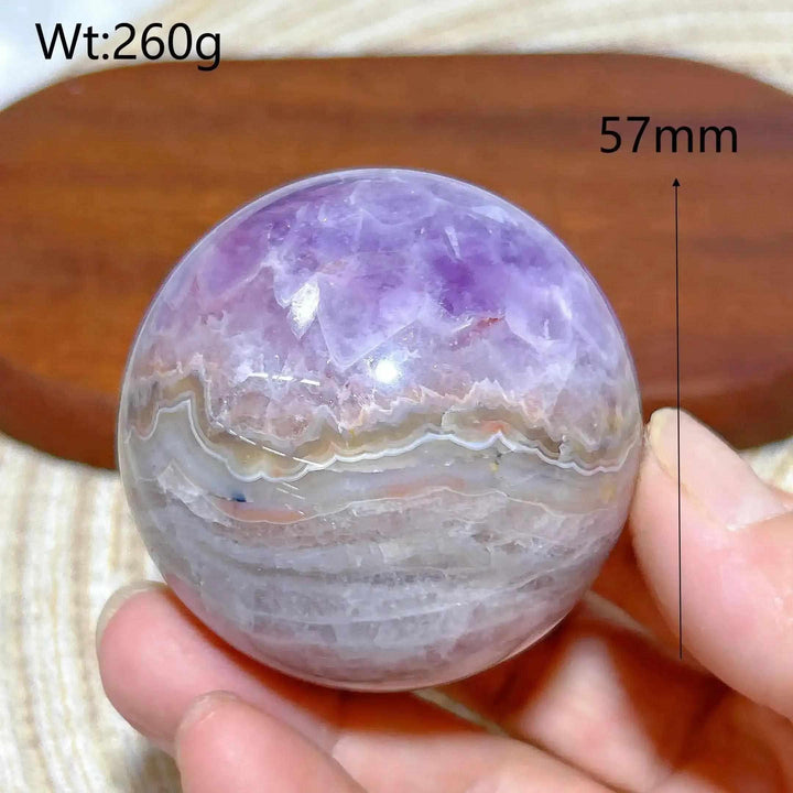 Hand-polished Amethyst Agate sphere featuring purple amethyst and banded white, gray, and brown patterns for peaceful focus.