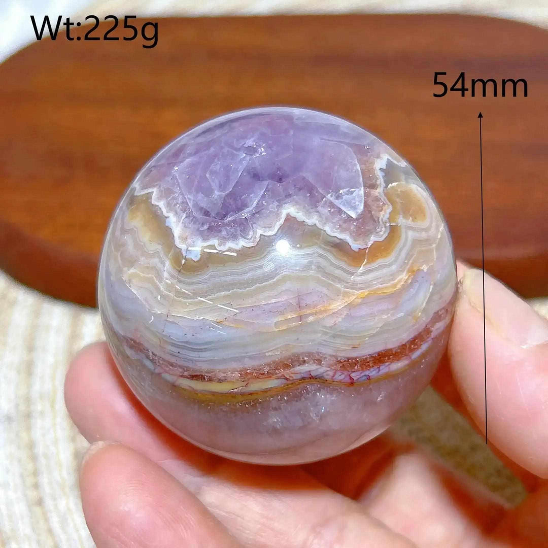 Hand-polished Amethyst Agate sphere with purple, white, and brown bands for peaceful focus and Crown Chakra meditation.