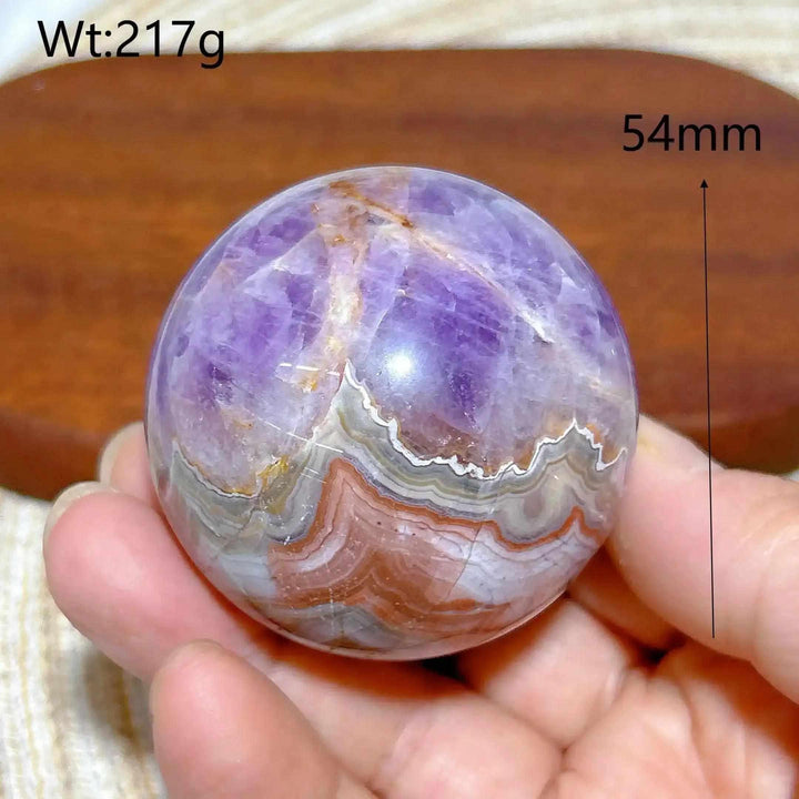 Hand-polished 54mm Amethyst Agate sphere featuring purple amethyst and banded white, gray, and brown patterns for meditation.