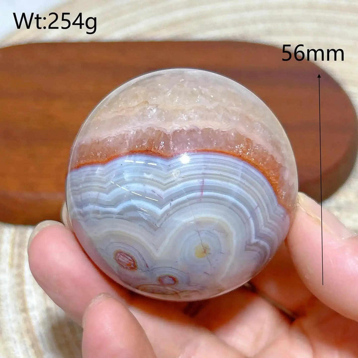 Hand-polished 56mm Amethyst Agate sphere featuring beautiful purple, white, and brown banded patterns for peaceful focus.
