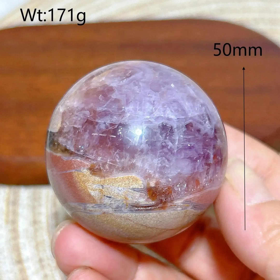 Hand-polished 50mm Amethyst Agate sphere featuring purple amethyst and banded white, gray, and brown patterns for focus.