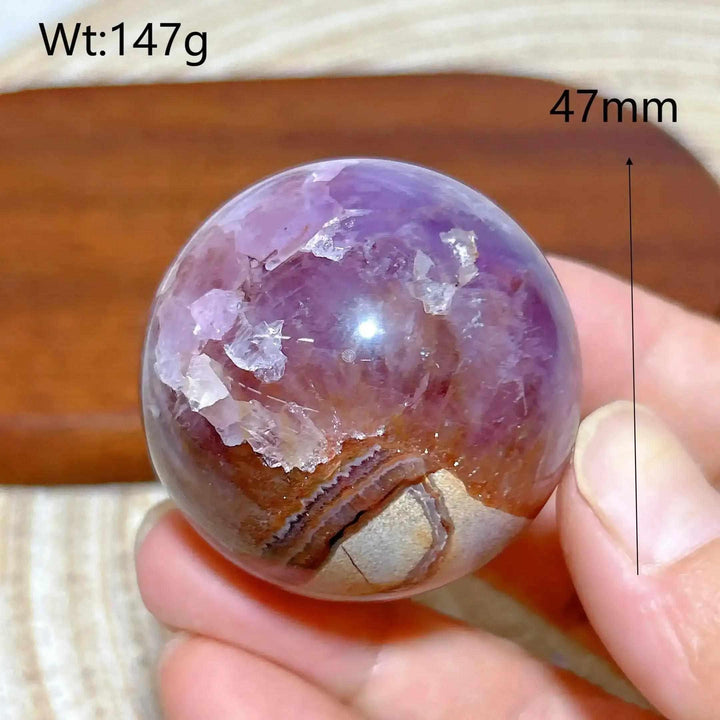 Hand-polished Amethyst Agate sphere featuring purple hues and banded brown agate for peaceful Crown Chakra meditation.