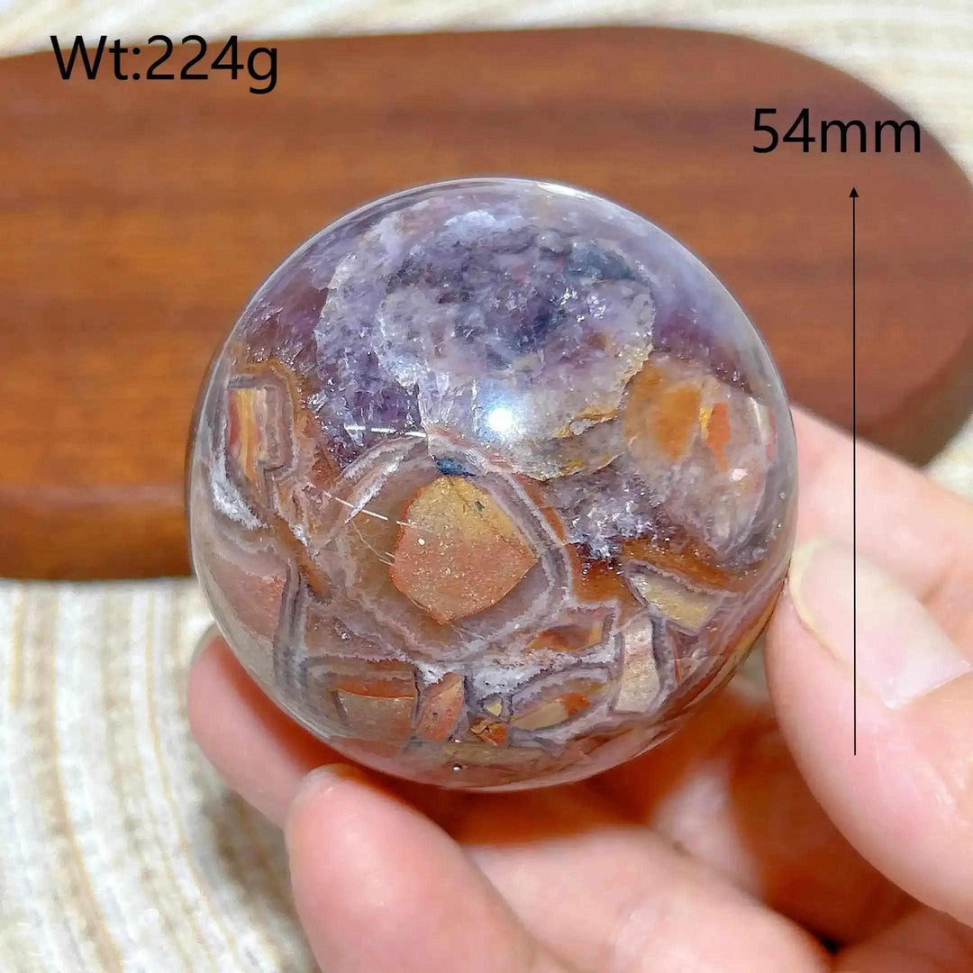Hand-polished Amethyst Agate sphere featuring purple amethyst and banded brown, gray, and white patterns for peaceful focus.