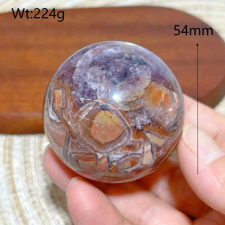 Hand-polished Amethyst Agate sphere featuring purple amethyst and banded brown, gray, and white patterns for peaceful focus.