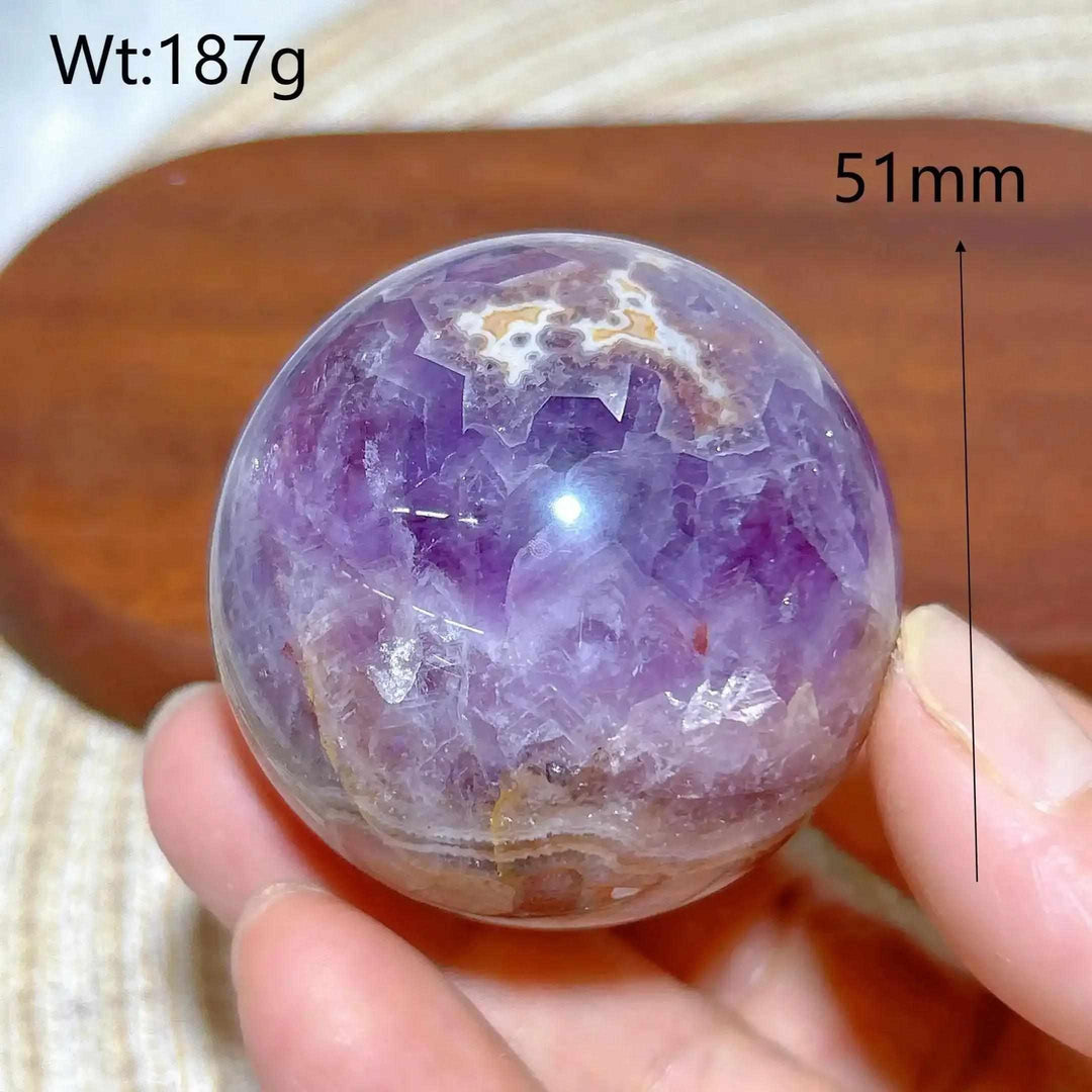 Polished 51mm Amethyst Agate sphere featuring deep purple crystals and banded white, gray, and brown patterns for meditation.