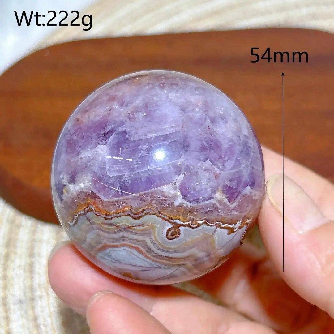 Hand-polished 54mm Amethyst Agate sphere featuring purple amethyst and banded white, gray, and brown patterns for meditation.