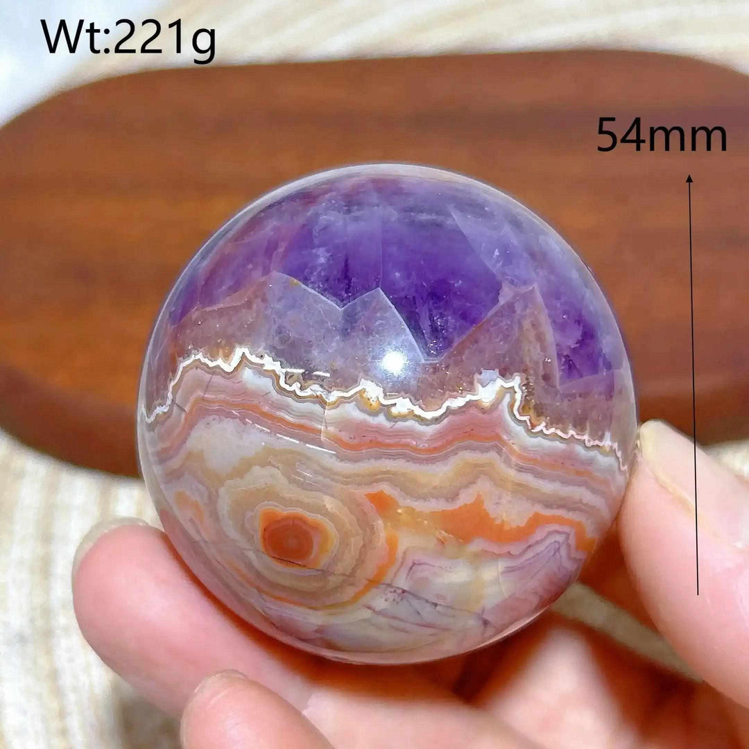 Hand-polished Amethyst Agate sphere featuring purple amethyst and banded white, gray, and orange agate for peaceful focus.