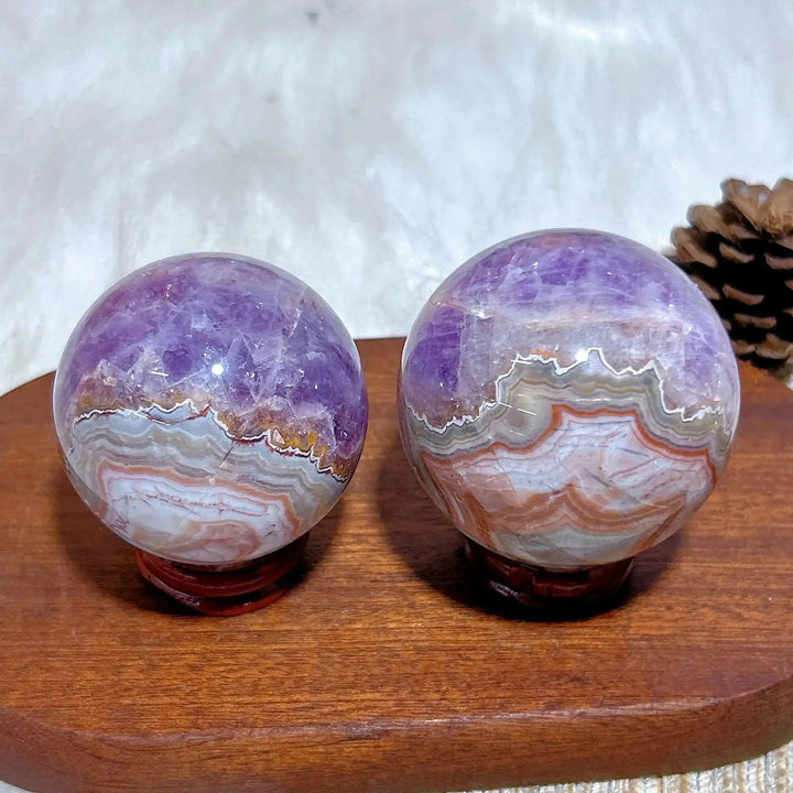 Two hand-polished Amethyst Agate spheres featuring purple amethyst and banded white, gray, and brown patterns for meditation.
