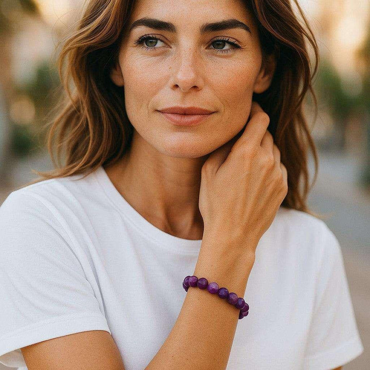 Woman wearing a calming Amethyst Beaded Bracelet, showcasing its soothing purple hues and elegant design for emotional balance.