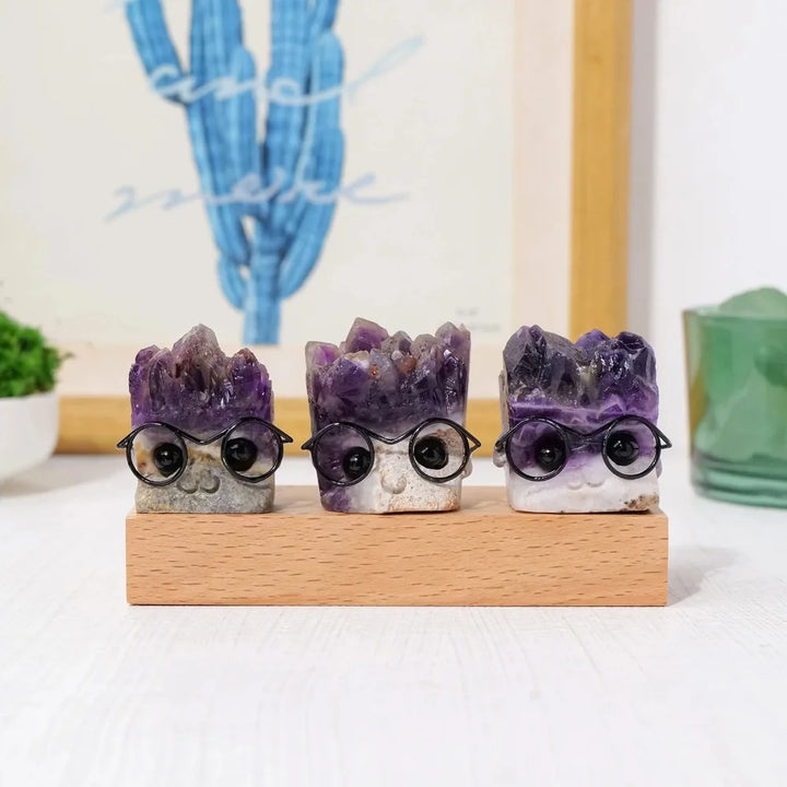 Three amethyst crystal hedgehog figurines with druzy spines and tiny glasses, perfect for Crown Chakra clarity and decor.
