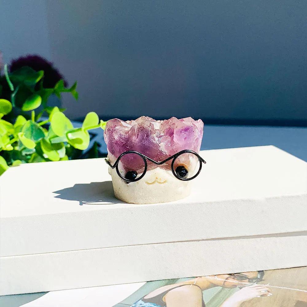 Cute amethyst crystal cluster hedgehog ornament wearing glasses, a charming purple quartz desk decor piece for healing.