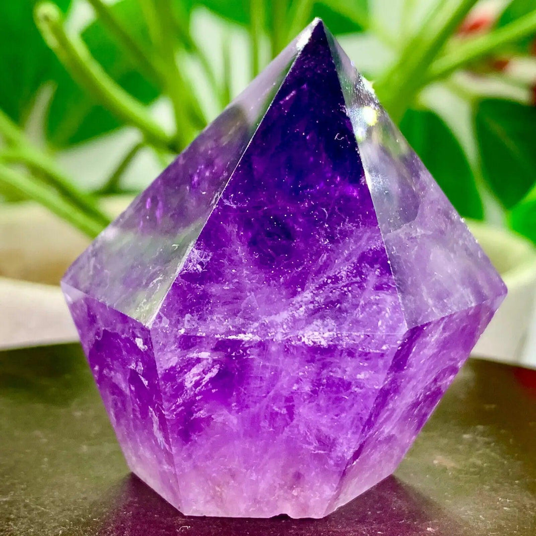 Natural purple crystal tower energy healing wand, a stunning faceted amethyst point for spiritual well-being.