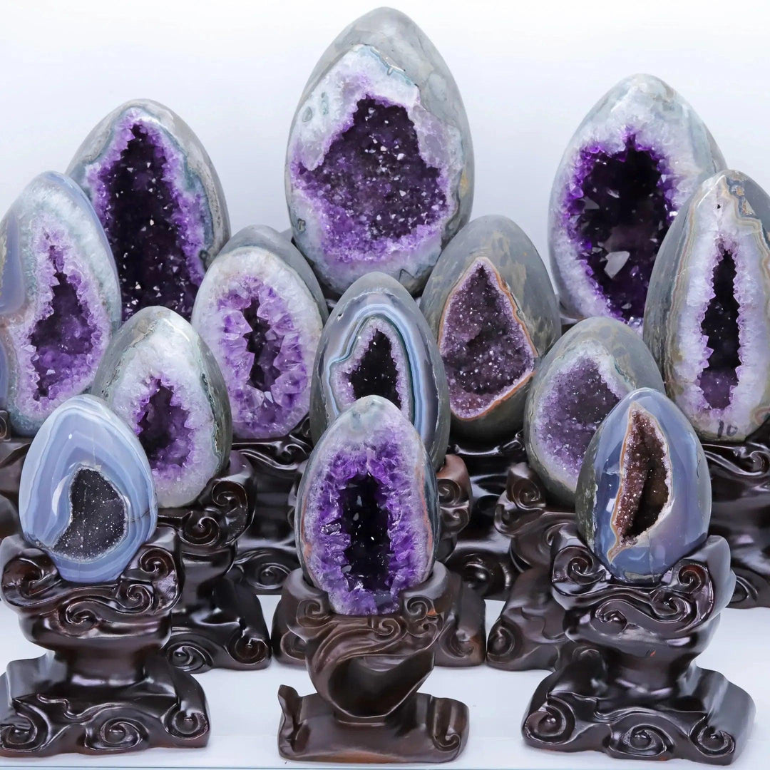 Natural Amethyst Crystal Geode Statement Pieces on stands, showcasing deep violet clusters for peace and tranquility.