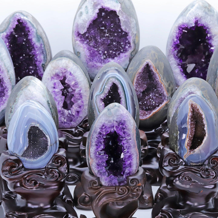 Raw Amethyst Crystal Natural Geode Statement Pieces on dark wood stands, radiating peace and tranquility.