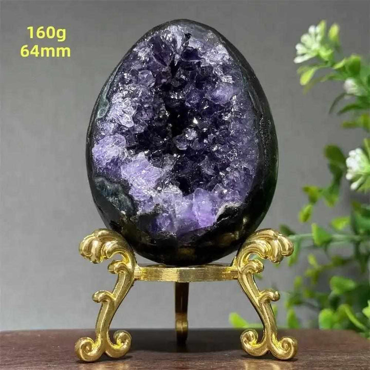 Amethyst geode dinosaur egg with deep purple crystals on a gold stand, perfect for Crown Chakra meditation and calm.