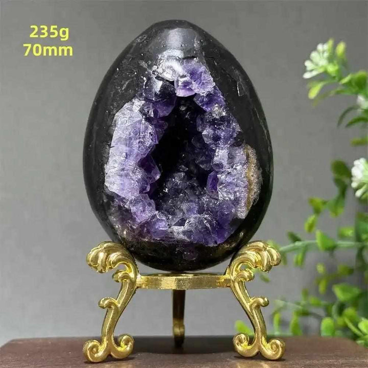 Amethyst geode dinosaur egg with sparkling purple crystals in a polished shell, perfect for meditation and calm.