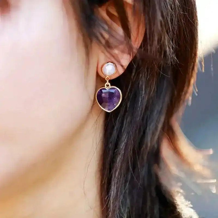 Amethyst Heart Stud Earrings, a polished purple heart crystal for calm and spiritual clarity, with a white stud.