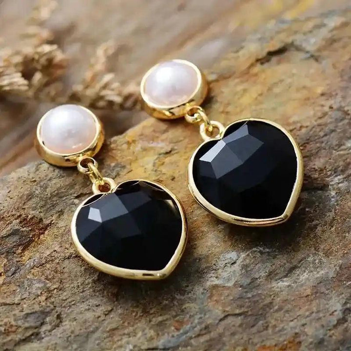 Elegant Black Onyx Heart Stud Earrings with pearl accents, offering protection and grounding energy.